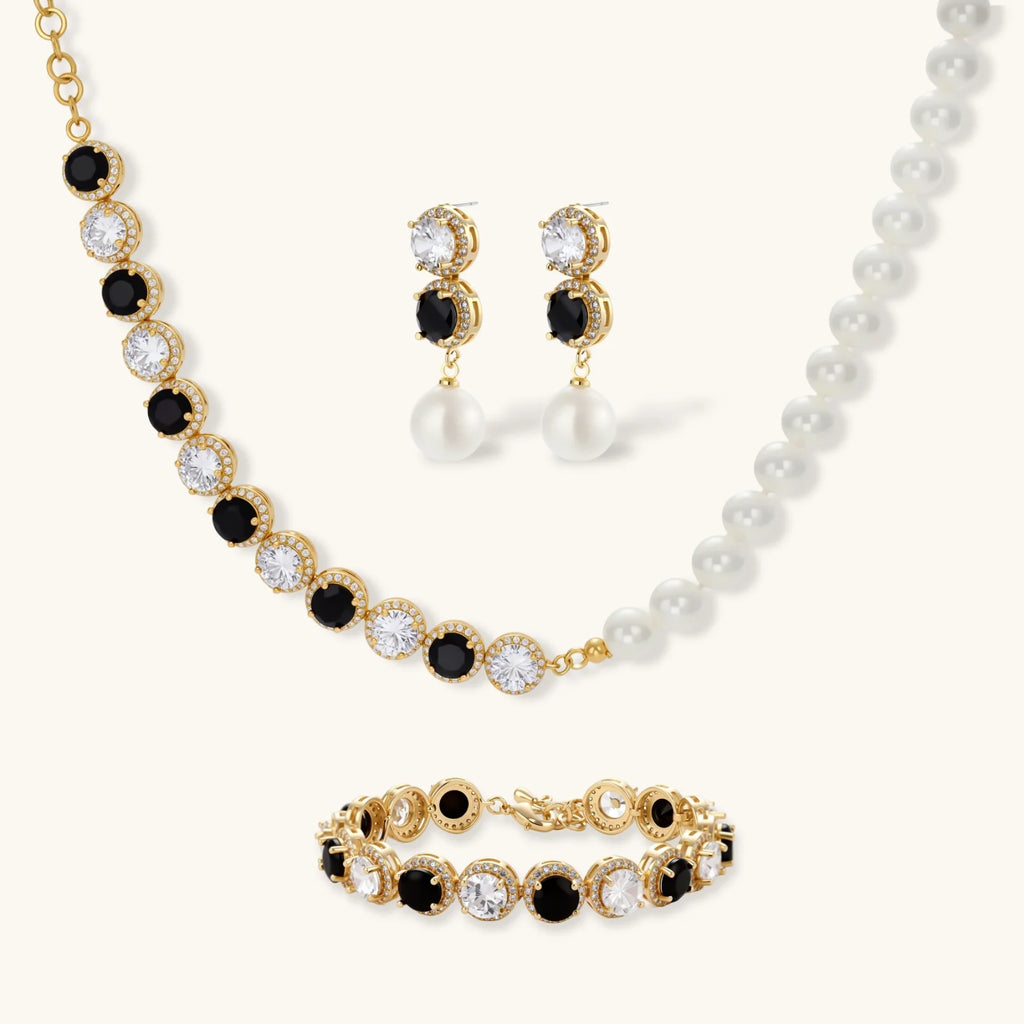 Gold-plated jewelry set with alternating black and clear cubic zirconia stones, featuring necklace, earrings and bracelet