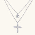 Two delicate sterling silver necklaces with moissanite stones - one solitaire pendant and one cross pendant on white background.