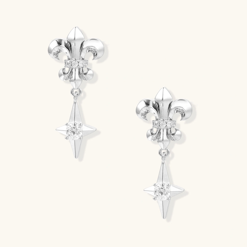 Silver fleur-de-lis drop earrings with geometric star and central crystal on white background