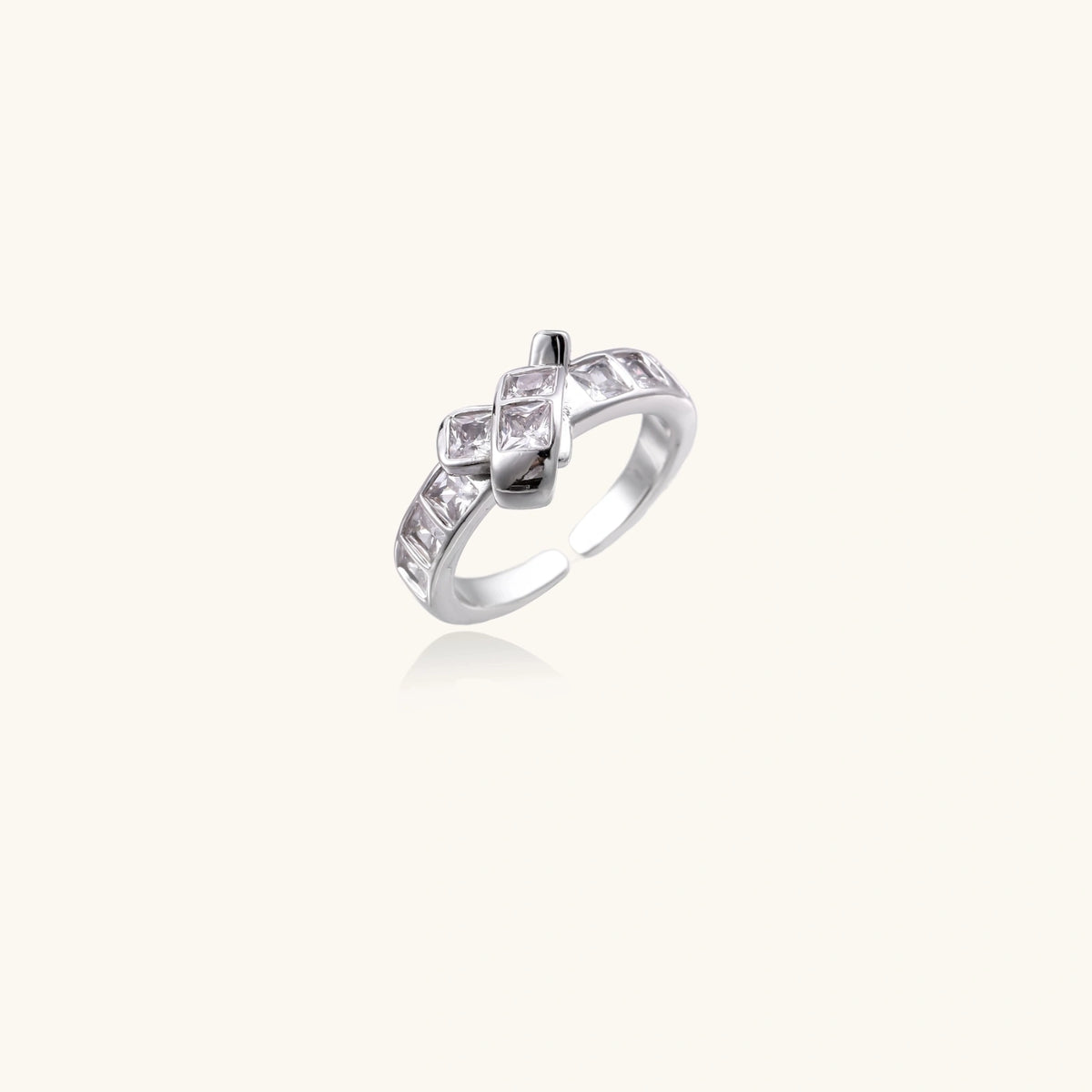 White gold plated adjustable ring featuring offset square cubic zirconia stones in an architectural stacked design