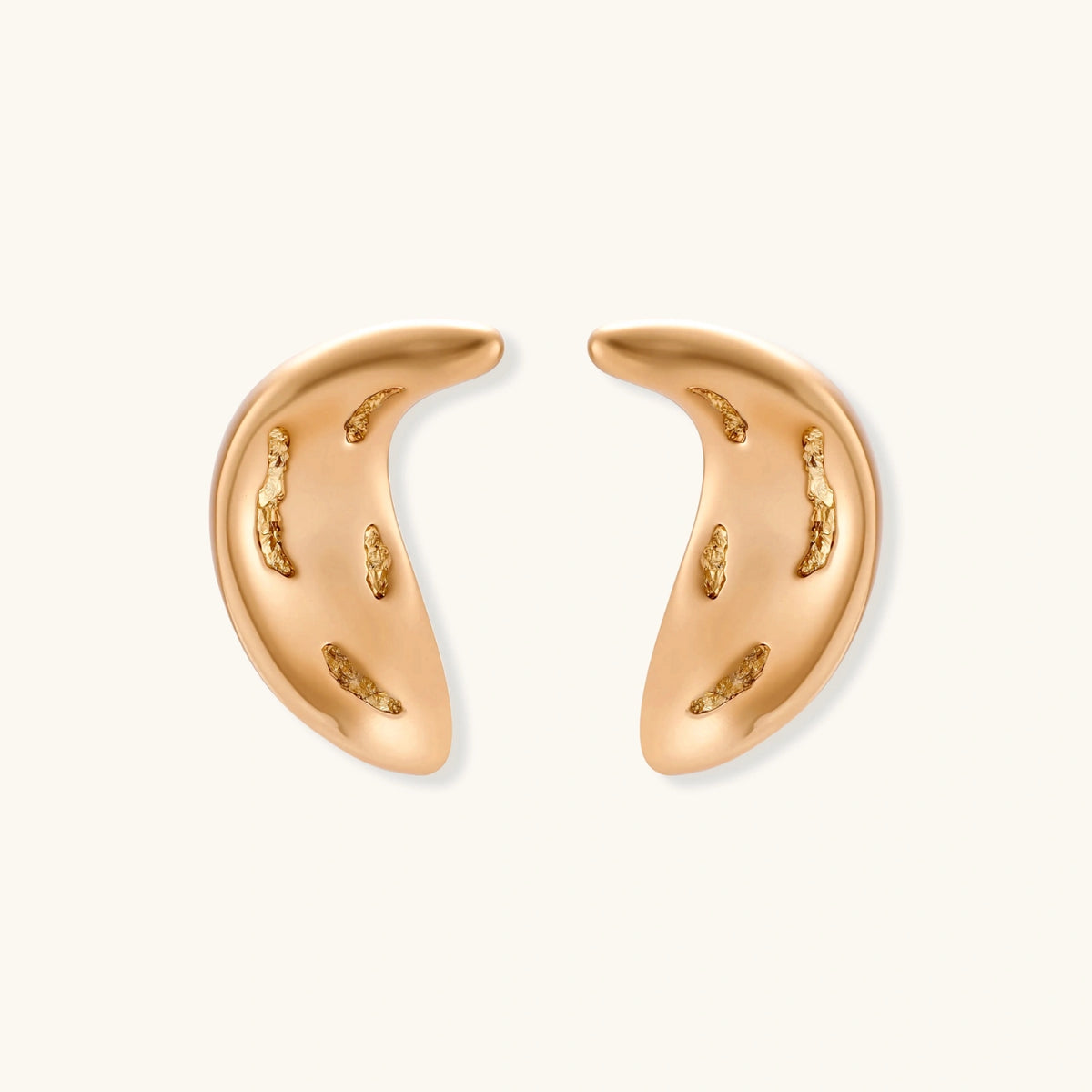 Gold-toned crescent moon pendant with textured surface on black adjustable cord, displayed with matching crescent earrings